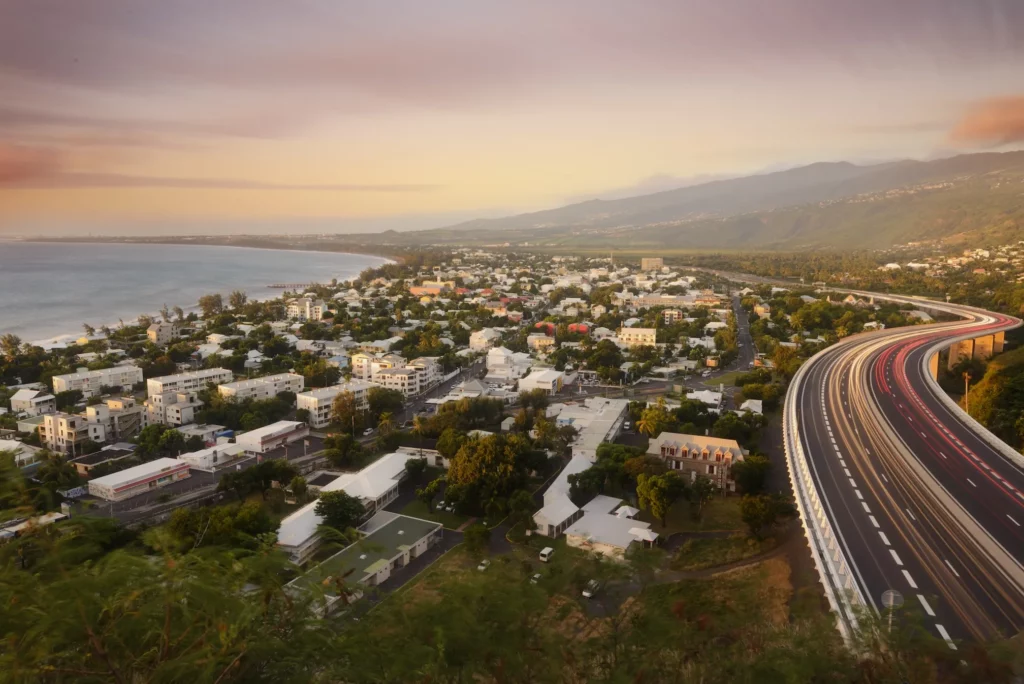 Vue aérienne de la Route des Tamarins longeant la côte Ouest de La Réunion au coucher du soleil